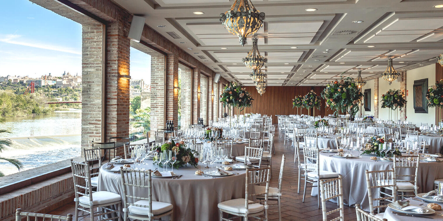 Salón panorámico del Mirador del Río con vistas a Toledo y el Río Tajo adornado y decorado para la celebración de una boda